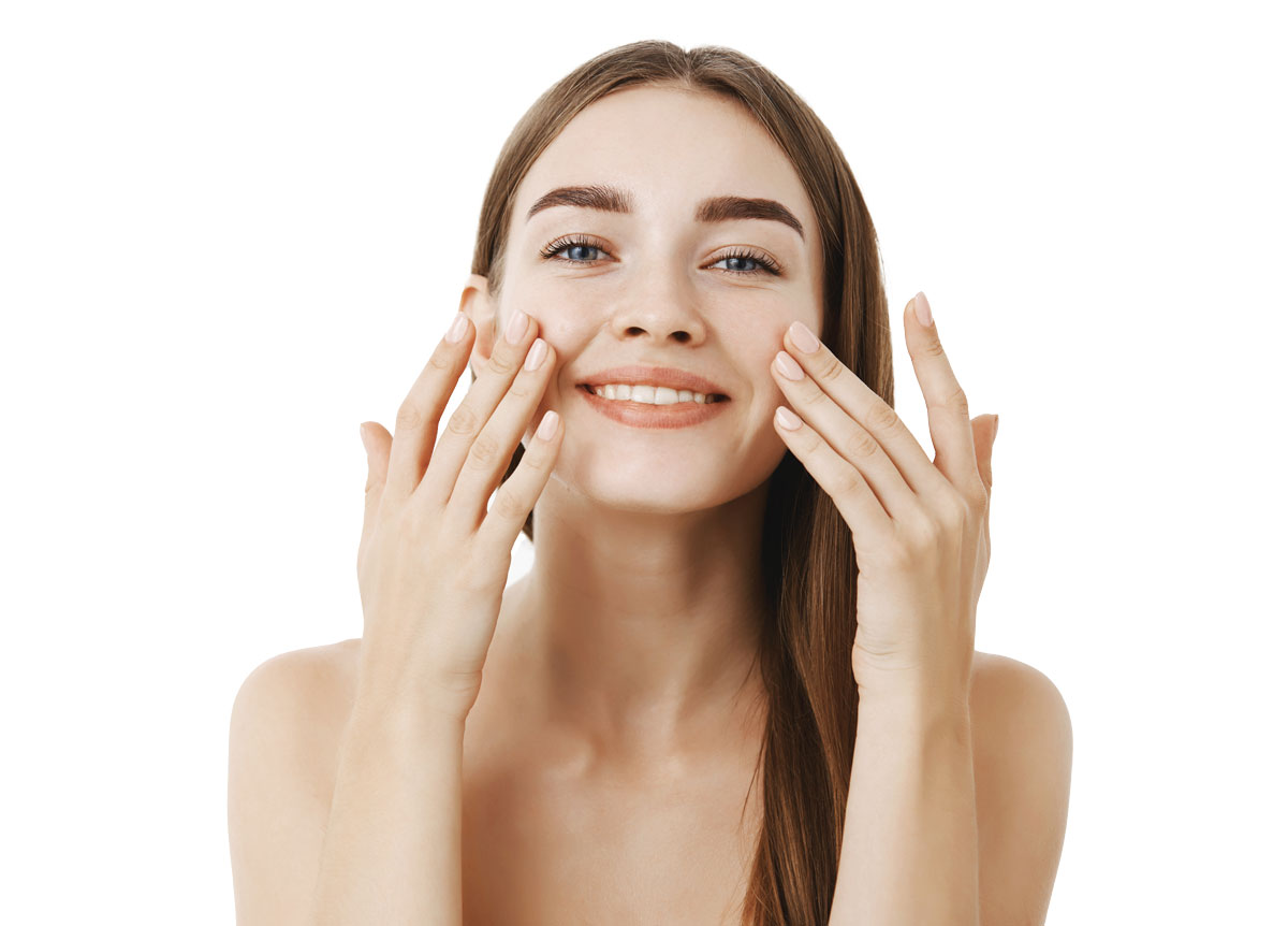 charming-relaxed-gentle-young-woman-making-cosmetological-procedure-applying-facial-cream-face-with-fingers-smiling-broadly-feeling-perfect-taking-care-skin