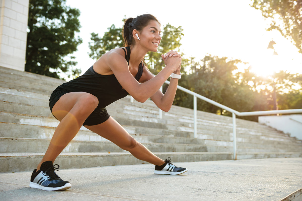 portrait-of-smiling-fitness-woman-in-earphones